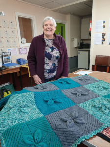 Barbara showing off the blanket she knitted for the WEN Spring Fair craft sale