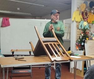 John teaching how to fix a wobbly chair